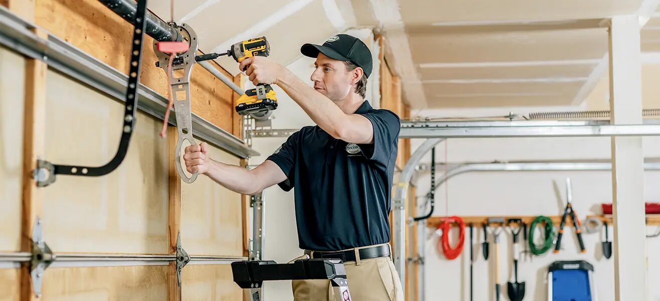 Technician installing a garage door opener